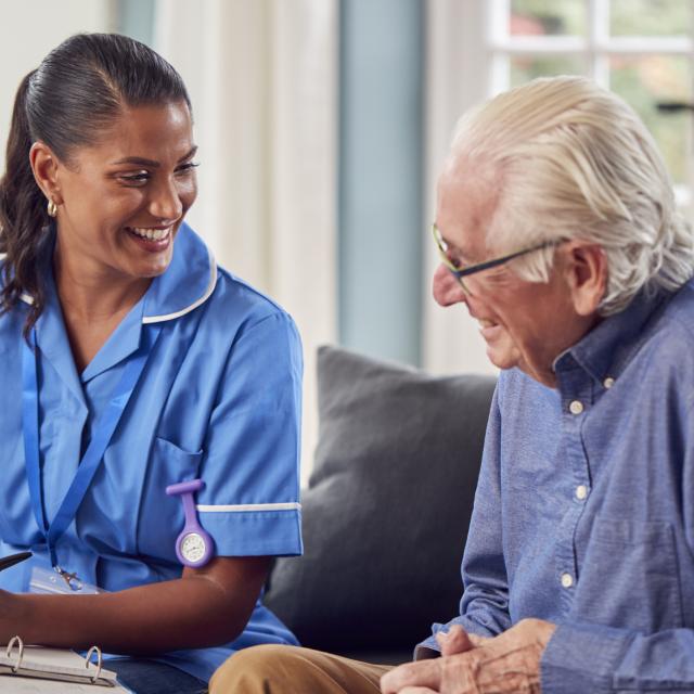 Nurse talking with an older male patient